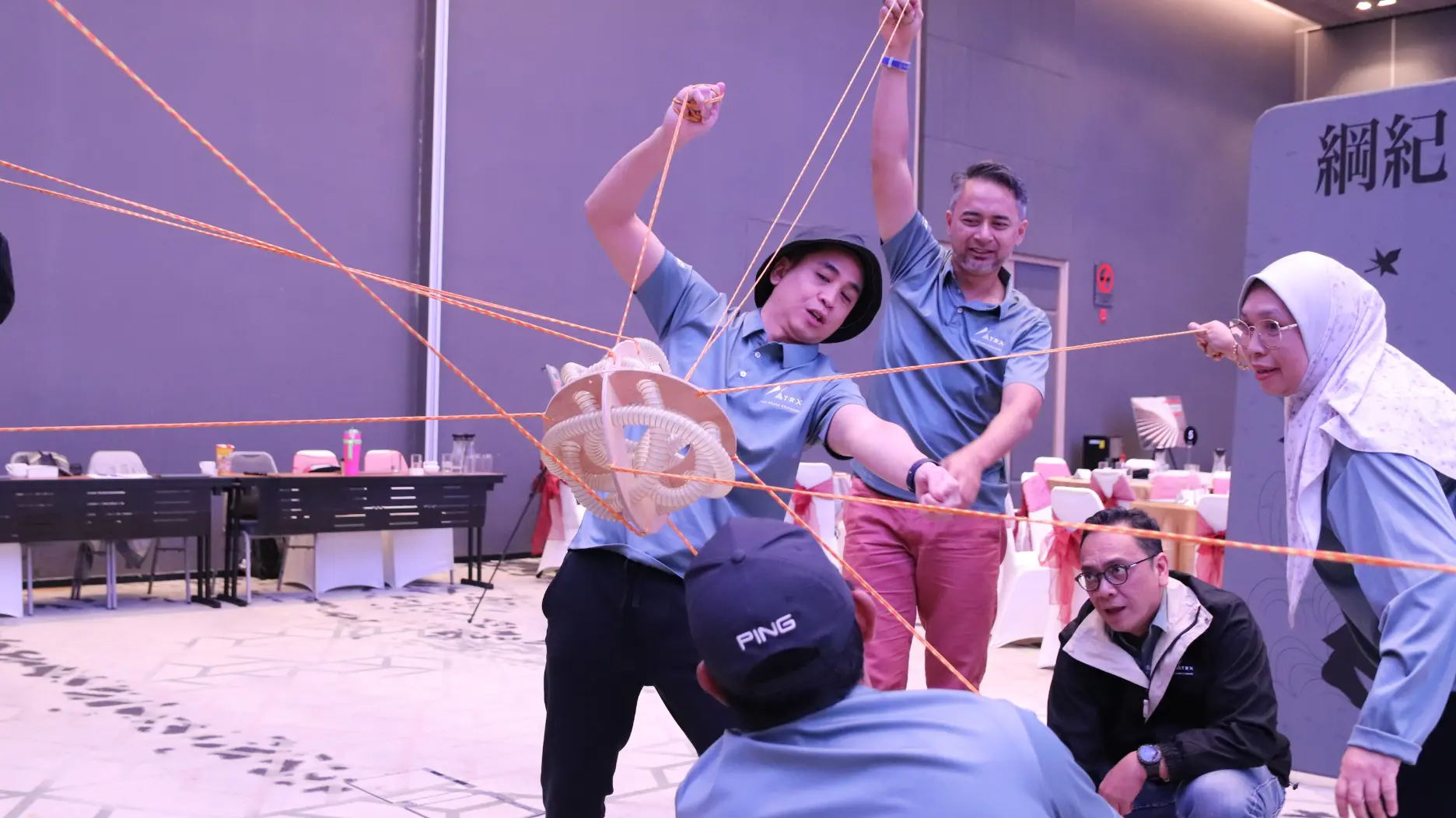 A Learning Edge facilitator engaging a seated cohort during a live team programme session