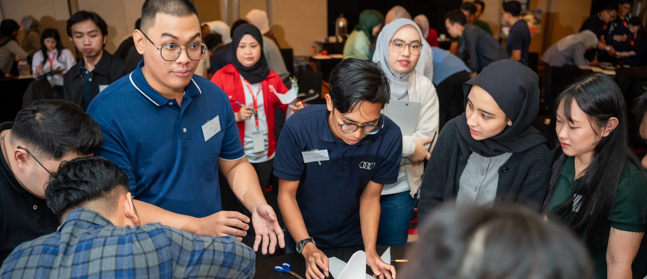 A graduate cohort taking part in a group presentation exercise during a Protege programme session